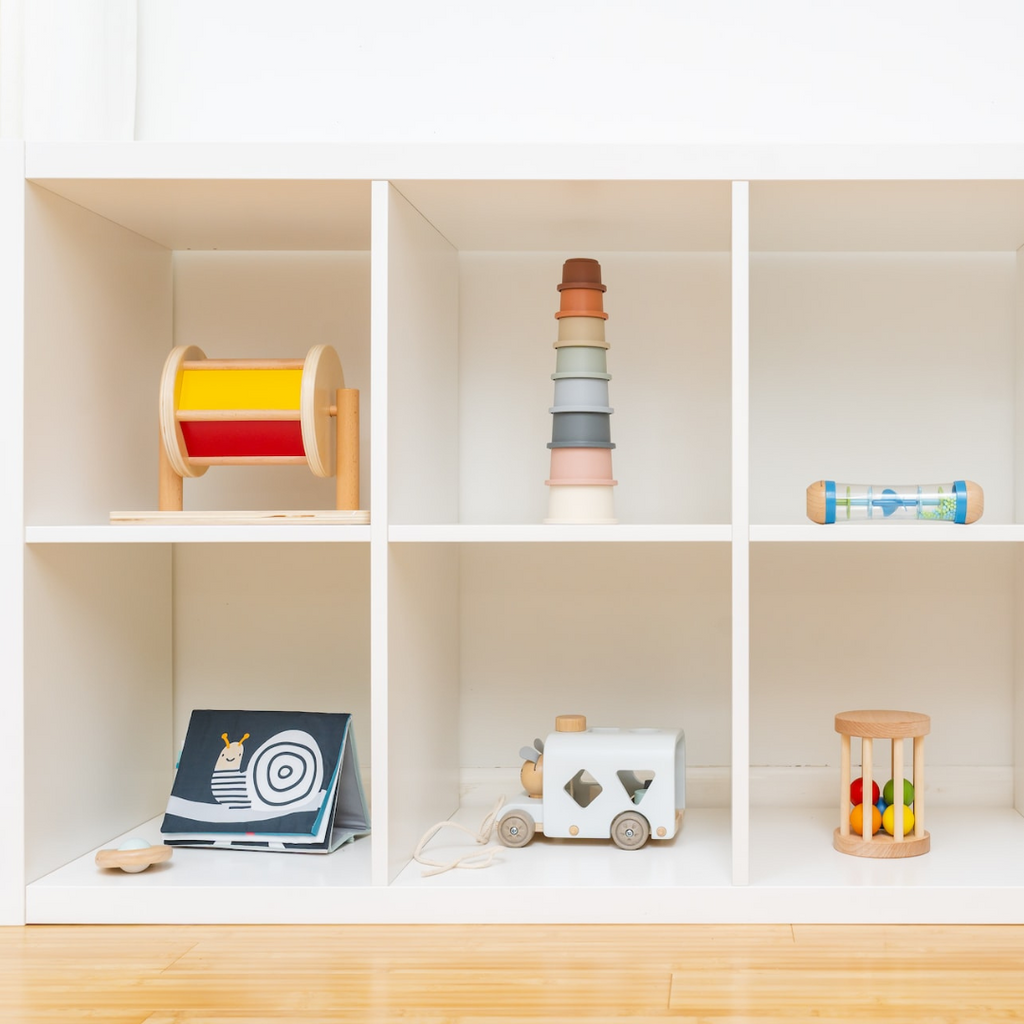 Babies toys in a white cabinet