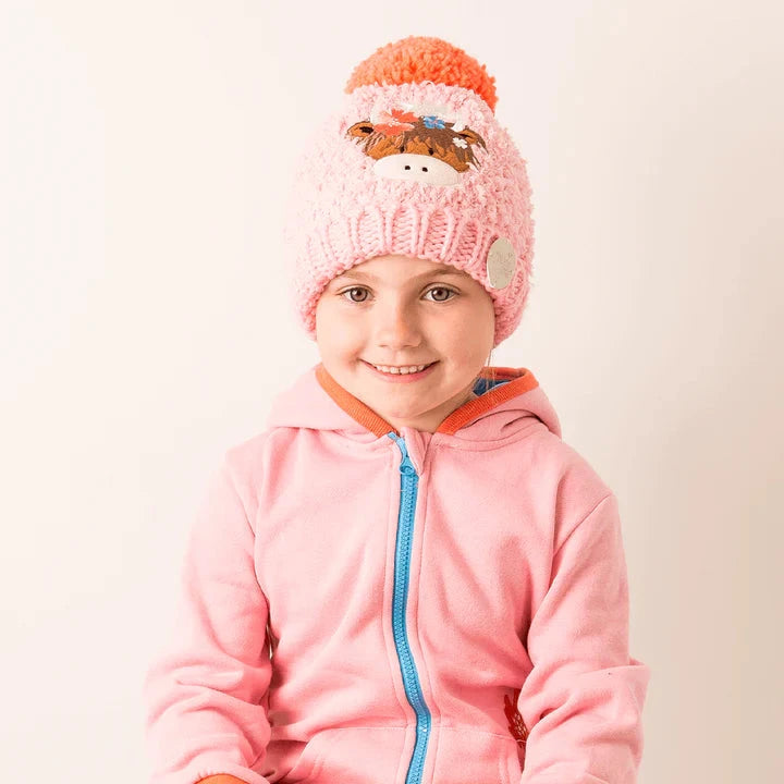 Child wearing a pink knitted hat and pink jacket with orange trim on a light background