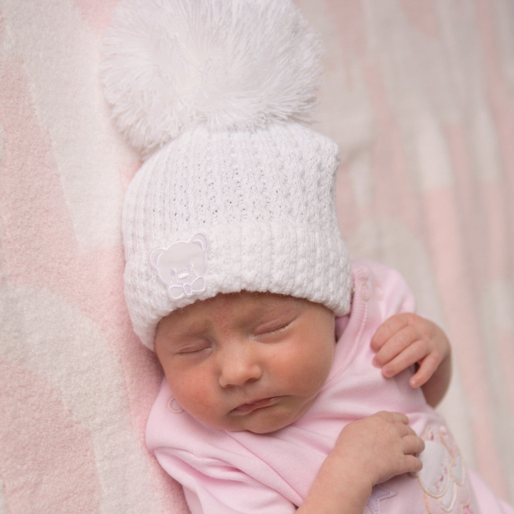 Sleeping baby wearing first size unisex knitted stripe teddy hat