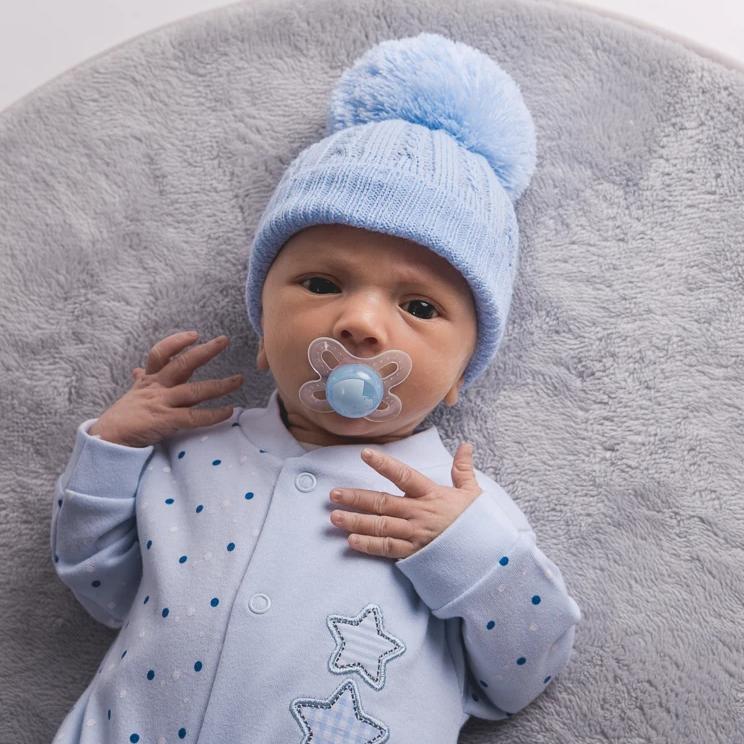 Baby wearing First Size Blue Cable Pom Hat