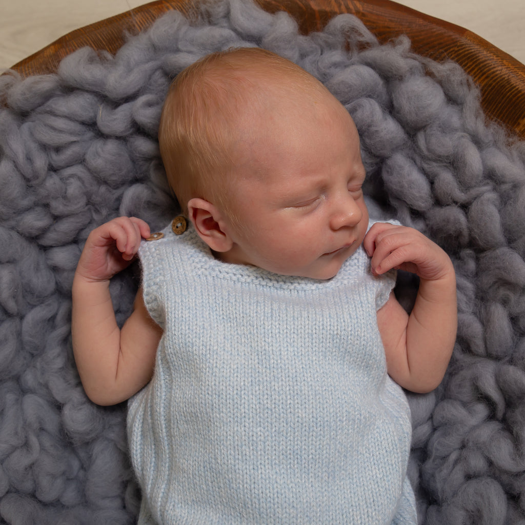 Sleeping baby wearing Blue Wool Knit Dungarees