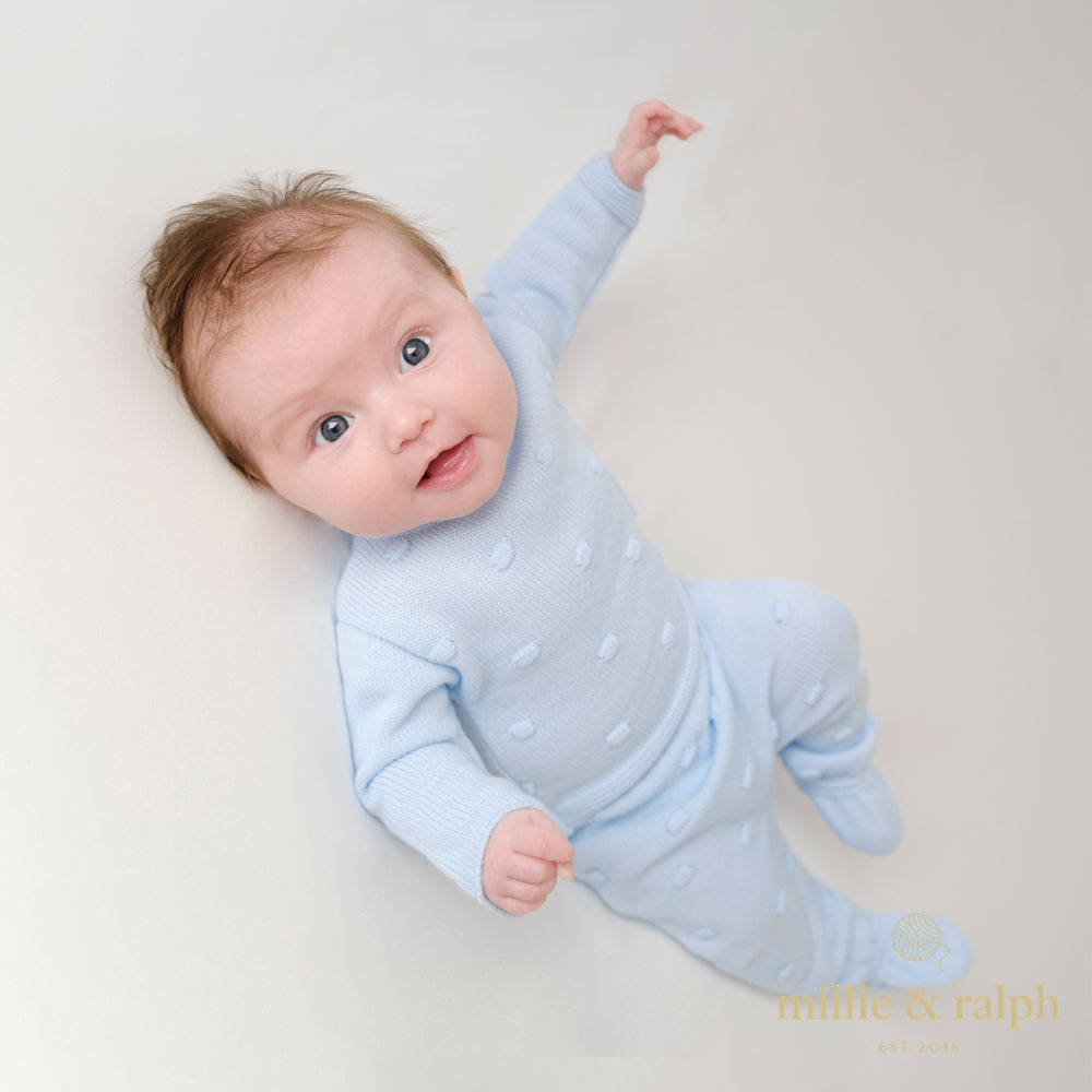 Baby on white background wearing blue bobble set