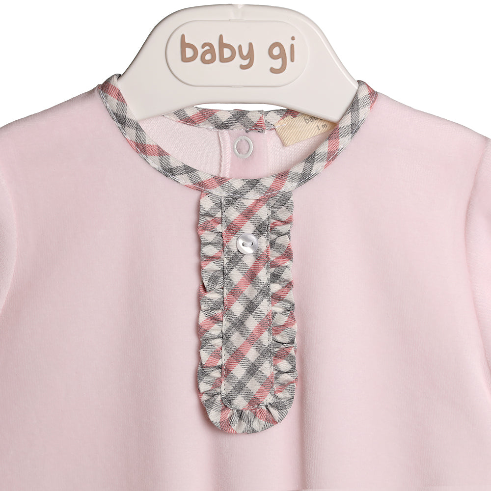 Close up of the neck of the baby pink velour gingham frill chest all in one